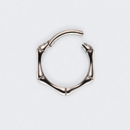Silver hoop earring on a light grey background