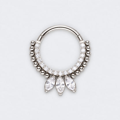 A silver-toned hoop piercing ring decorated with small clear stones and three dangling marquise-cut clear stones, shown on a light gray background.