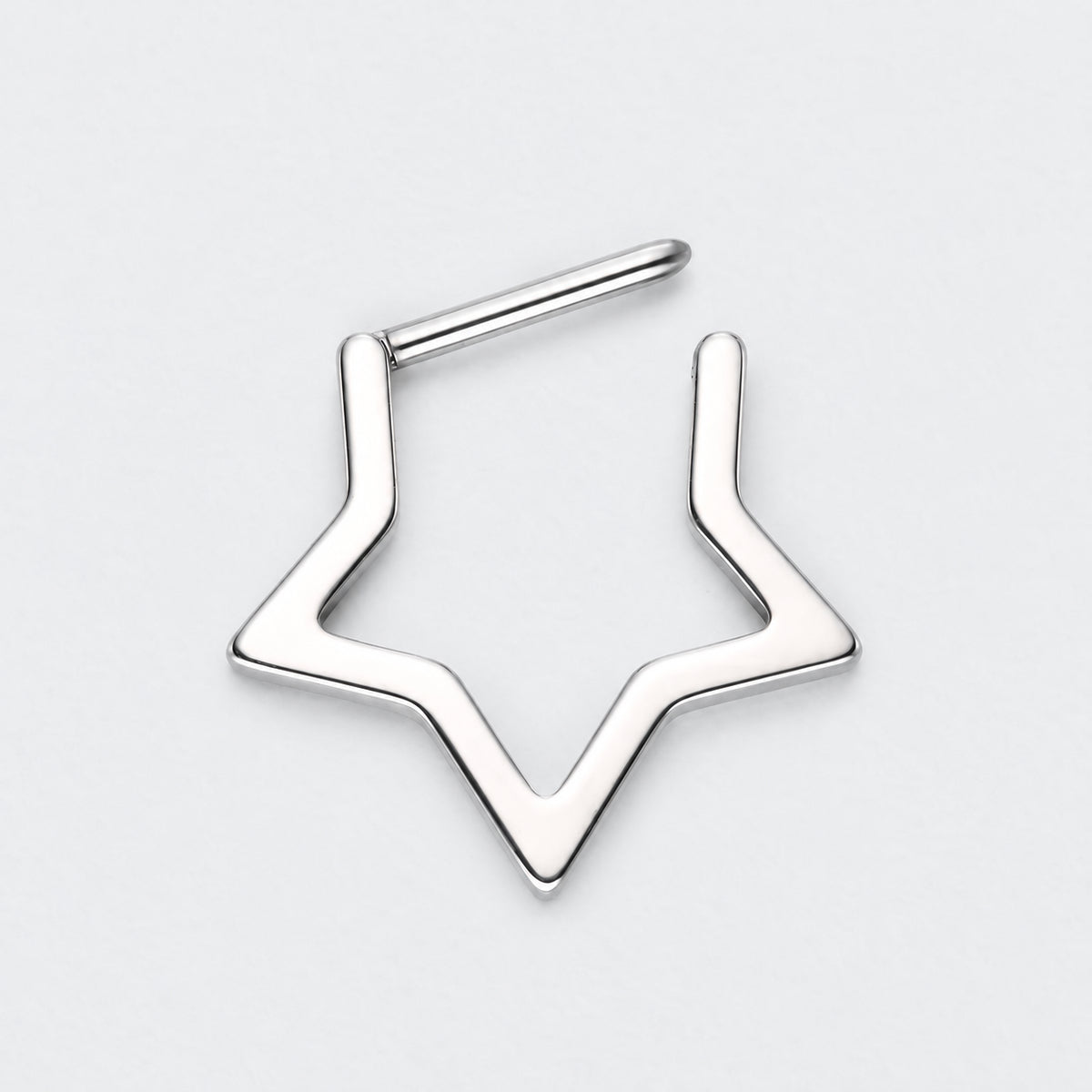 A silver-toned metal nose stud with a geometric, open star-like outline design, shown on a clean light gray background.